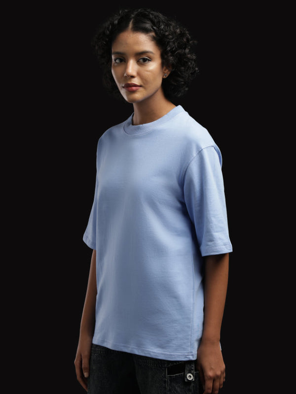 ADEL & VIDA Azure Horizon oversized sky blue t-shirt worn by a model with curly hair against a black background