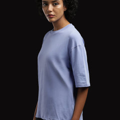 ADEL & VIDA Azure Horizon oversized sky blue t-shirt worn by a model with curly hair against a black background