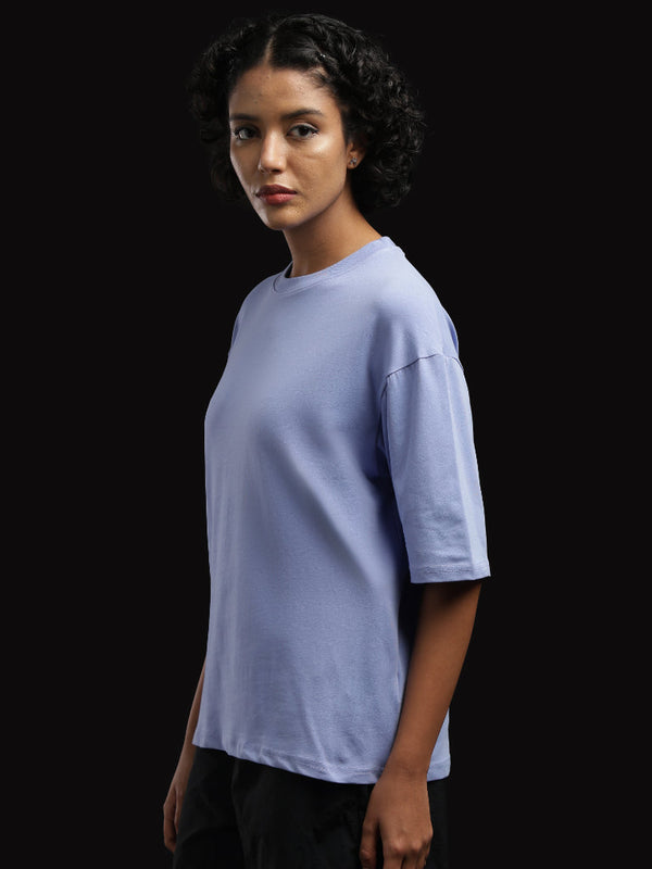 ADEL & VIDA Azure Horizon oversized sky blue t-shirt worn by a model with curly hair against a black background