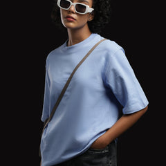 ADEL & VIDA Azure Horizon oversized sky blue t-shirt worn by a model with white sunglasses against a black background