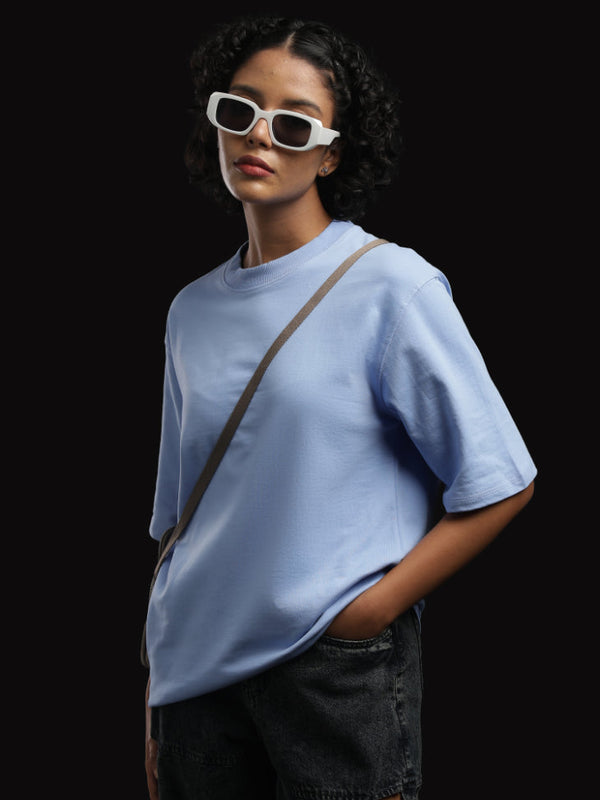 ADEL & VIDA Azure Horizon oversized sky blue t-shirt worn by a model with white sunglasses against a black background