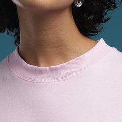 ADEL & VIDA baby pink oversized crew neck t-shirt with soft breathable fabric worn by a model with silver earrings.