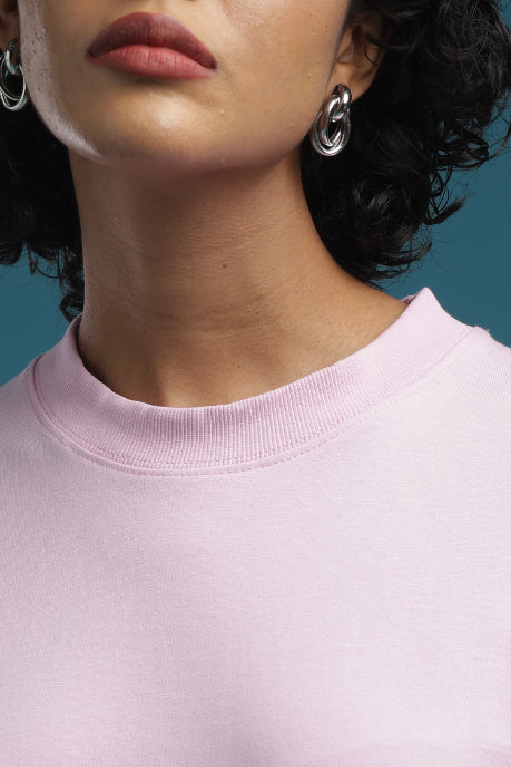 ADEL & VIDA baby pink oversized crew neck t-shirt with soft breathable fabric worn by a model with silver earrings.