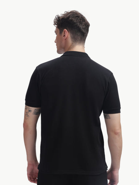Back view of a man wearing an ADEL & VIDA black regular fit Onyx polo t-shirt with a soft and breathable texture.
