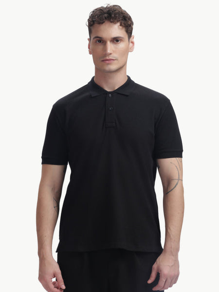 ADEL & VIDA black regular fit polo t-shirt worn by a male model, featuring a soft, breathable, and stretchable fabric.