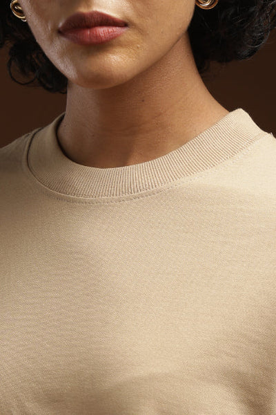 ADEL & VIDA beige oversized crew neck t-shirt with soft ribbed collar detail on a model