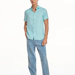 Model wearing ADEL & VIDA Mint Horizon blue striped slim fit shirt with cuban collar and half sleeves