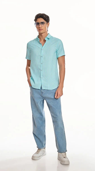 Model wearing ADEL & VIDA Mint Horizon blue striped slim fit shirt with cuban collar and half sleeves