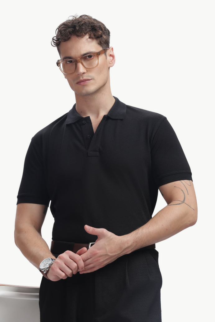 ADEL & VIDA Onyx black regular fit polo t-shirt worn by a male model with glasses