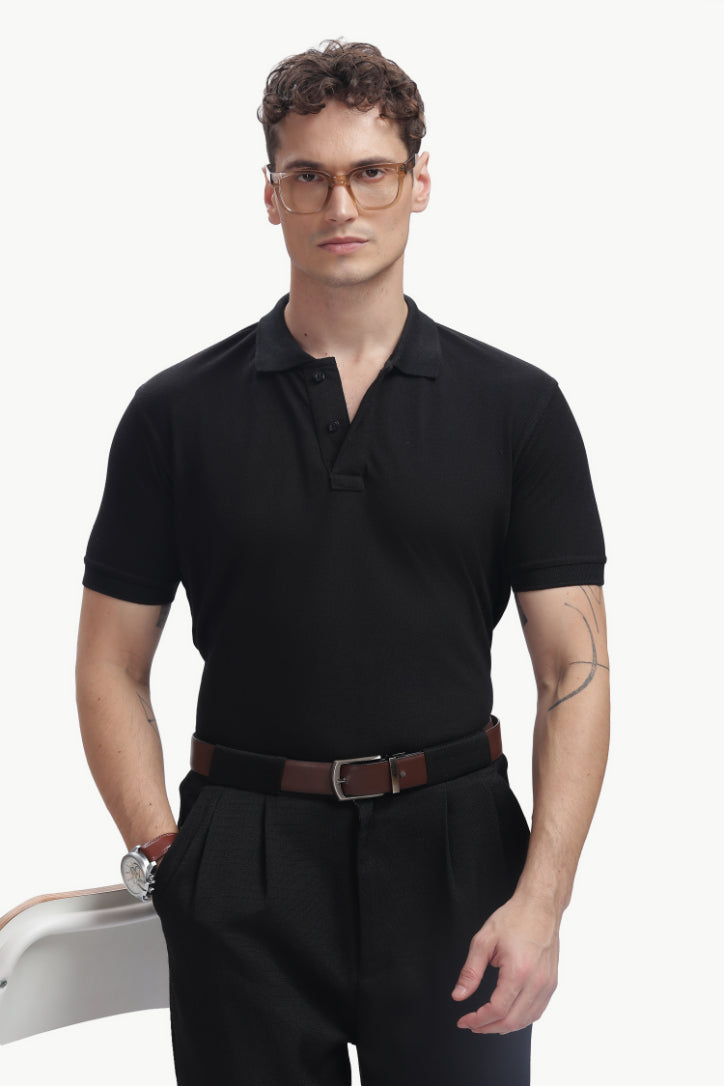 ADEL & VIDA Onyx black regular fit polo shirt worn by a model with glasses, featuring a soft and breathable fabric.