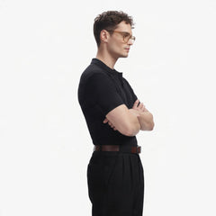 ADEL & VIDA Onyx black regular fit polo shirt worn by a model with glasses, side profile view