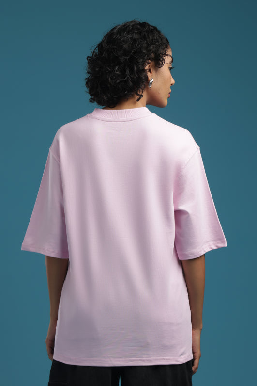 Back view of a woman wearing an ADEL & VIDA oversized baby pink t-shirt with a soft, breathable fabric finish.