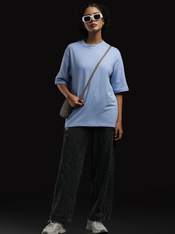 ADEL & VIDA Azure Horizon oversized sky blue t-shirt worn by a model with sunglasses and a crossbody bag