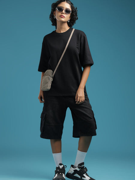 ADEL & VIDA Raven Form oversized black t-shirt paired with black cargo shorts and a crossbody bag on a model
