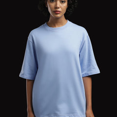 ADEL & VIDA sky blue oversized t-shirt worn by a model with short curly hair against a black background