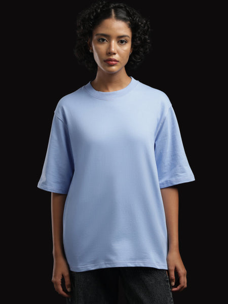 ADEL & VIDA sky blue oversized t-shirt worn by a model with short curly hair against a black background