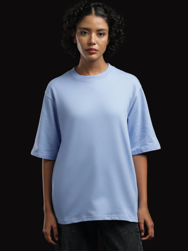 ADEL & VIDA sky blue oversized t-shirt worn by a model with short curly hair against a black background