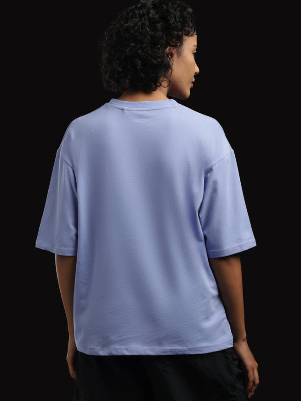 ADEL & VIDA Azure Horizon oversized sky blue t-shirt worn by a woman, back view showing soft breathable fabric.