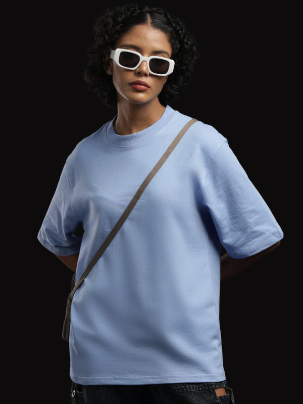 ADEL & VIDA Azure Horizon oversized sky blue t-shirt worn by a model with white sunglasses against a black background