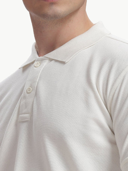 ADEL & VIDA white Pureline polo shirt with a classic collar and button placket, featuring a soft, breathable texture.