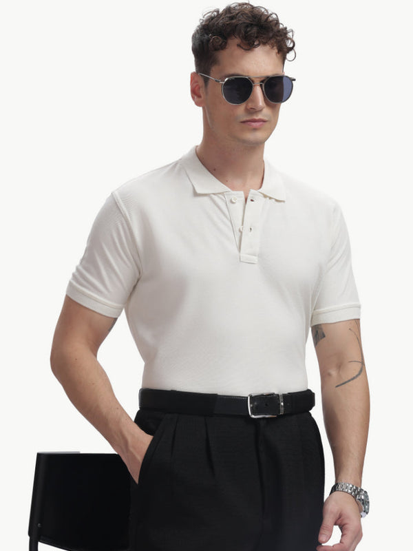 ADEL & VIDA white Pureline polo t-shirt worn by a model with sunglasses and black trousers