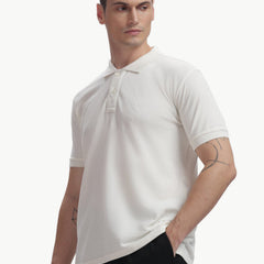 ADEL & VIDA white Pureline polo t-shirt worn by a model, featuring a soft, breathable, and stretchable fabric.
