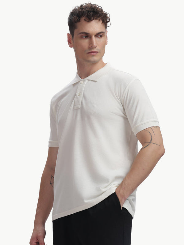 ADEL & VIDA white Pureline polo t-shirt worn by a model, featuring a soft, breathable, and stretchable fabric.